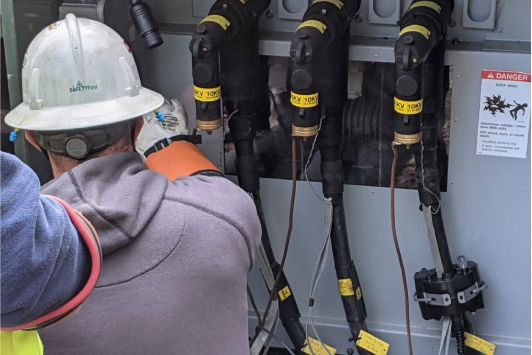 Person in a hard hat working on underground lines.