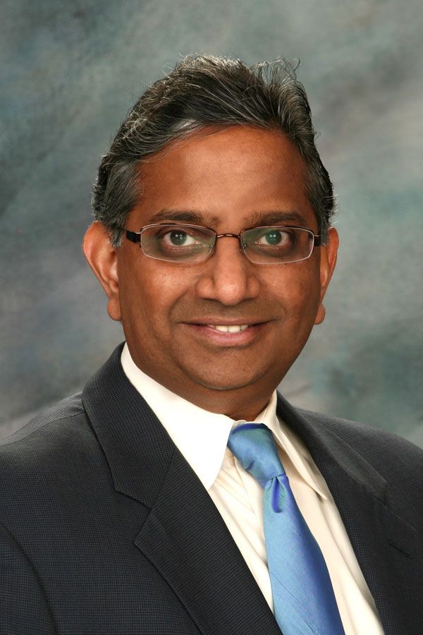 Headshot of Giri Iyer wearing a suit and smiling.