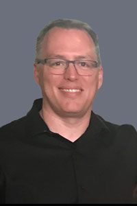 sentient-energy-Darrell Way Headshot of Darrell Way wearing a black polo and smiling.